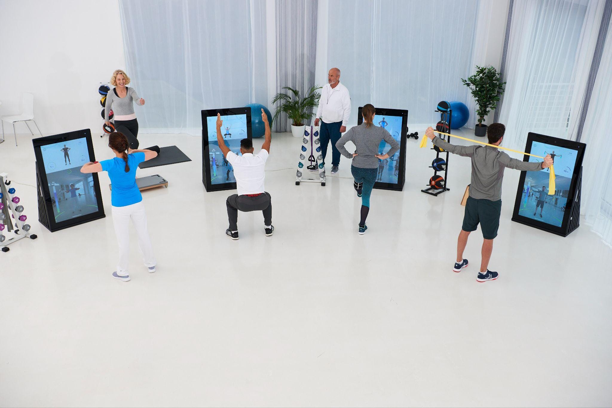 People training at several Pixformance Stations in a bright studio